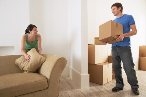 Professional movers handling furniture during a Tootingbec flat move